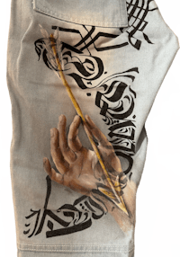 a pair of jeans with a hand painted on them