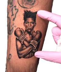 a tattoo of a man with a boxing glove on his arm