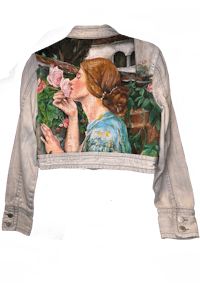 a denim jacket with a painting of a woman kissing a rose