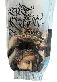 a pair of sweatpants with an image of a woman wearing a crown