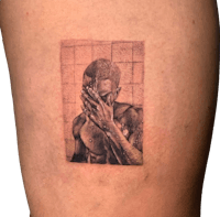 a tattoo of a man with his hand on his face